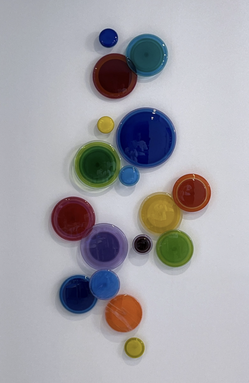 Celebration by LouAnn Wukitsch at Art Leaders Gallery. Colorful group of different sized glass circles.